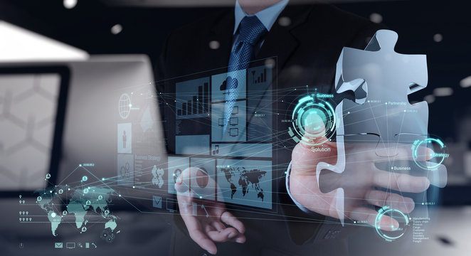 businessman hand working with computer interface show puzzles