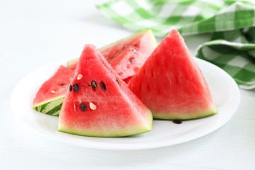 Tasty slice of watermelon on white wooden background
