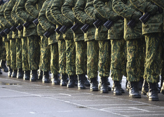 Soldiers in camouflage military uniform on rest position