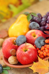 Naklejka na ściany i meble Autumn still life with assorted fruit, berries and nuts