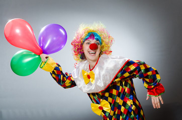 Clown with balloons in funny concept