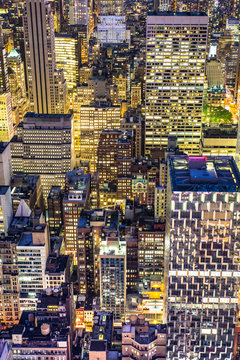 Golden cityscape of New York City buildings and lights at night