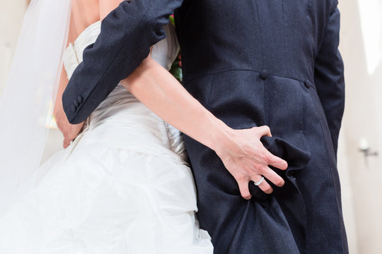Bride grabbing ass of groom at wedding in church