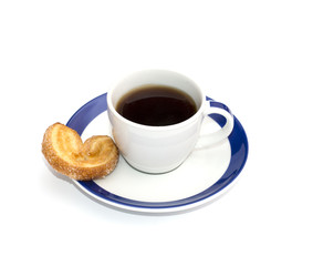 coffee on a saucer with a blue border and one cookies