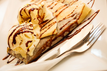 Pancake with ice cream and chocolate sauce