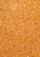 Processed organic wheat grains as agricultural background.