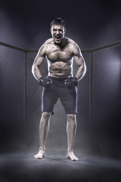 Excited MMA fighter in a cage shouting loud