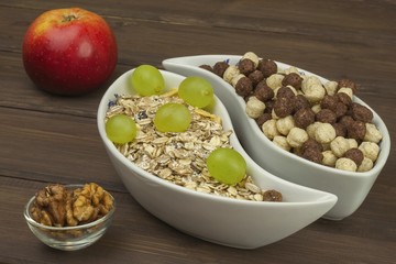 Healthy Diet breakfast of oatmeal, cereal and fruit. Foods full of energy for athletes. The concept of diet food. Preparing homemade breakfast. Vegetarian diet. Food on a wooden table.

