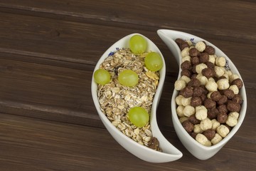 Healthy Diet breakfast of oatmeal, cereal and fruit. Foods full of energy for athletes. The concept of diet food. Preparing homemade breakfast. Vegetarian diet. Food on a wooden table.

