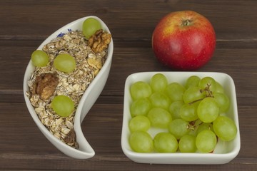 Healthy Diet breakfast of oatmeal, cereal and fruit. Foods full of energy for athletes. The concept of diet food. Preparing homemade breakfast. Vegetarian diet. Food on a wooden table.

