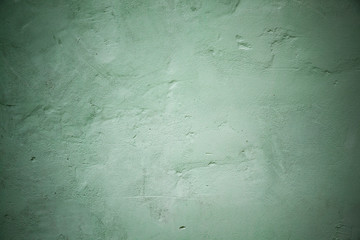 Green concrete wall with relief details, background
