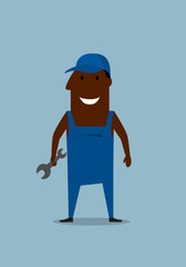 Happy smiling mechanic or repairman with wrench