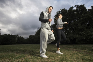 Attractive young couple running in the park