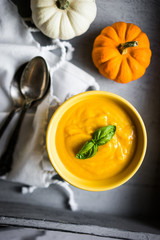 Pumpkin soup on rustic background
