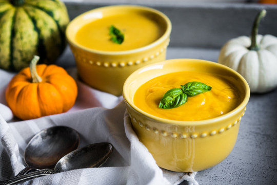 Pumpkin soup on rustic background