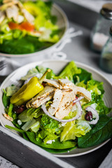 Green chicken salad on wooden background