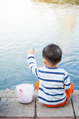 Boy feeding fish