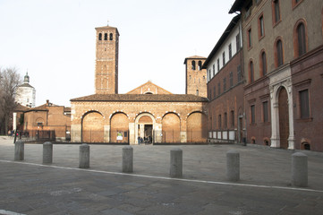 Fototapeta na wymiar Frontal sight of the basilica and the two bell tower of saint Ambrogio of Milan, Italy