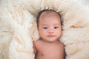 Cute baby in fur blanket, close up