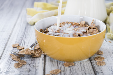 Pouring Milk in a bowl with Cornflakes
