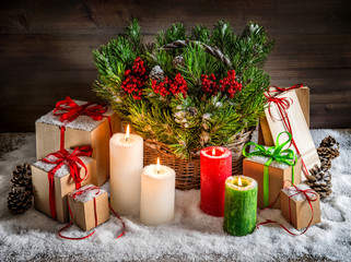 Christmas still life burning candles and gift box light effects