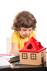 Toddler boy drawing at table