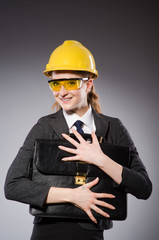 Construction worker in helmet against gray