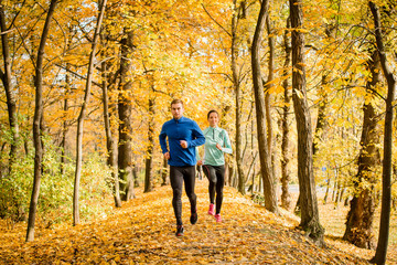Couple running in autumn nature