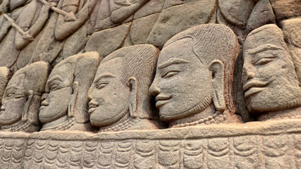 Fototapeta na wymiar Stone faces of Khmer warriors