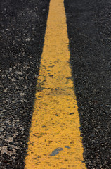 Obraz premium old yellow line on road background.