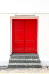 Red door on the white wall