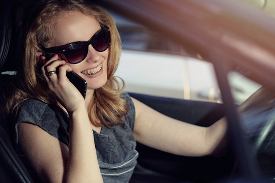 Woman talking on the phone in the car