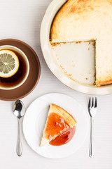 Wedge of homemade cheesecake with tea