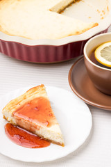 Wedge of homemade cheesecake with tea