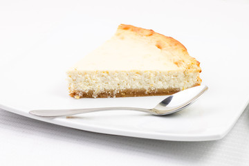 Wedge of cheesecake with teaspoon