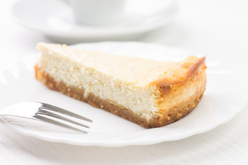 Piece of cheesecake on white plate