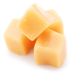Sweet caramel candies on the white background.