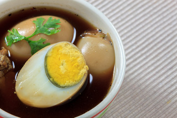 stewed eggs or eggs and pork in brown sauce by Thai food.