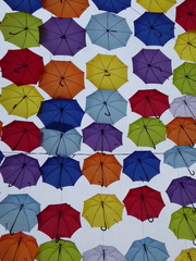 Fototapeta na wymiar Colorful umbrellas with sky in background