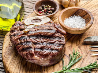 Beef steaks  with spices on a wooden tray.