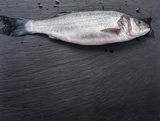 Seabass fish on the graphite board.