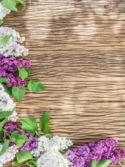 Blooming lilac flowers on the old wooden table.