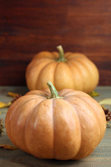 pumpkin with leaves on wooden background