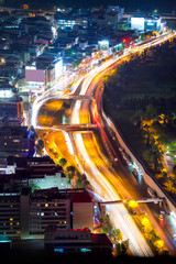 Night road with motion traffic in residential district, city