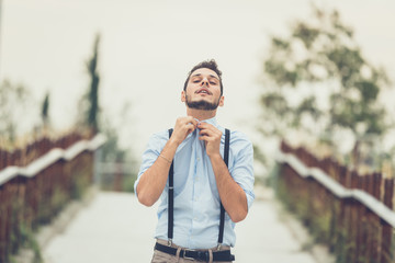 Young handsome man posing in an urban context