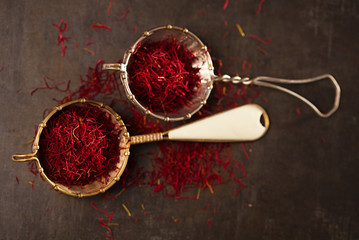saffron spice threads and powder  in vintage  old sieve