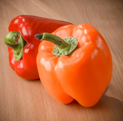 Fresh orange and red peppers on a cutting board