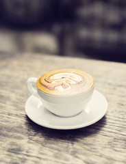 Cup of cappuccino on a wooden table