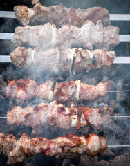 grilled skewers on coals with smoke
