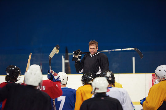 ice hockey players team meeting with trainer